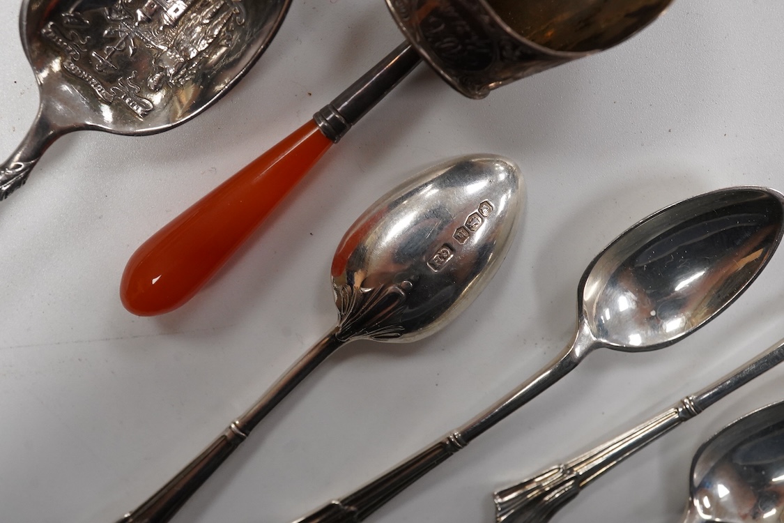 A collection of assorted silver to include five napkin rings including two pairs, a cased pair of glass butter dishes with silver butter knives, five golf related teaspoons, a cased set of six sterling cocktail sticks wi